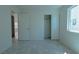 This bedroom has tile floors and a view out to the neighborhood at 4481 Faberge Ave, Las Vegas, NV 89115