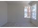 This bedroom has tile floors and a window allowing natural light to flow in at 4481 Faberge Ave, Las Vegas, NV 89115