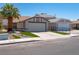 Exterior view of a single-story home with a palm tree and manicured landscaping at 4481 Faberge Ave, Las Vegas, NV 89115