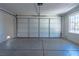 Spacious garage with a large door and a window offering natural light at 4481 Faberge Ave, Las Vegas, NV 89115