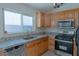 Contemporary kitchen with stainless steel appliances, granite countertops, tile flooring, and a window at 4481 Faberge Ave, Las Vegas, NV 89115