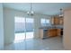 Eat in kitchen featuring tile flooring, modern appliances, granite countertops, and natural light at 4481 Faberge Ave, Las Vegas, NV 89115