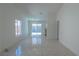 Bright living room with tile flooring, neutral walls, and ample natural light from the sliding glass door at 4481 Faberge Ave, Las Vegas, NV 89115