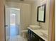 Bright bathroom featuring double sink vanity, and a door leading to the bedroom at 4951 Ivylyn Ct, Las Vegas, NV 89122
