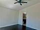A blank bedroom featuring dark hardwood floors and a doorway to a bathroom at 4951 Ivylyn Ct, Las Vegas, NV 89122