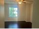 Bedroom features dark wood floors, a ceiling fan, and a bright window at 4951 Ivylyn Ct, Las Vegas, NV 89122