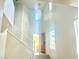 High ceiling foyer and staircase with abundant natural light beaming through the front door and clerestory windows at 4951 Ivylyn Ct, Las Vegas, NV 89122