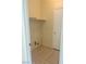 A simple laundry room features neutral tile floors and a single shelf for storage at 4951 Ivylyn Ct, Las Vegas, NV 89122