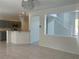Spacious and open floor plan featuring tile flooring, kitchen bar, and neutral walls for versatile decor options at 4951 Ivylyn Ct, Las Vegas, NV 89122
