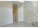 Light-filled entry features a staircase with white railing and tile flooring, offering a modern aesthetic at 4951 Ivylyn Ct, Las Vegas, NV 89122