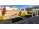 A nicely designed backyard features artificial grass, a brick paver patio, and a well-maintained privacy wall at 528 Sunny Pointe St, Henderson, NV 89011