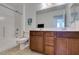 Bathroom with a dual sink vanity, a toilet, and a shower with a tub at 528 Sunny Pointe St, Henderson, NV 89011