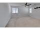 Spacious bedroom features neutral carpet, neutral paint, updated ceiling fan, and great natural light at 528 Sunny Pointe St, Henderson, NV 89011