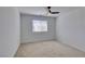A well-lit carpeted bedroom featuring a modern ceiling fan and a window at 528 Sunny Pointe St, Henderson, NV 89011