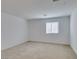 An empty room with neutral carpet and a window that lets in natural light at 528 Sunny Pointe St, Henderson, NV 89011