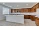Well-lit kitchen features a large island, stainless appliances, and ample dark wood cabinet storage space at 528 Sunny Pointe St, Henderson, NV 89011