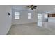 Carpeted living room flows into tiled kitchen, with bright sliding glass doors, perfect for entertaining at 528 Sunny Pointe St, Henderson, NV 89011