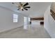 Open living room with tile flooring, flows into the kitchen with updated light fixture, perfect for entertaining at 528 Sunny Pointe St, Henderson, NV 89011