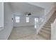 A view of the living room featuring a ceiling fan and stairs to the second floor at 528 Sunny Pointe St, Henderson, NV 89011