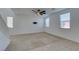 Neutral living room with neutral paint, carpet, and updated ceiling fan; bracket for TV mounted on wall at 528 Sunny Pointe St, Henderson, NV 89011