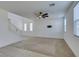 Spacious living room features neutral paint, carpet, and updated ceiling fan with lots of natural light at 528 Sunny Pointe St, Henderson, NV 89011
