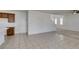 Open-concept living room with tile floors seamlessly connects to the kitchen, creating a bright and airy space at 528 Sunny Pointe St, Henderson, NV 89011