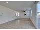Bright living room with access to the backyard patio through sliding glass doors and stairs leading to the upper level at 528 Sunny Pointe St, Henderson, NV 89011