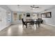 Bright dining room with wood floors, table and chairs, fireplace, and multiple windows providing plenty of natural light at 5433 Escallonia St, Las Vegas, NV 89149
