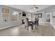 Well-lit dining room featuring wood floors, a fireplace, a dining table, and views to the outside at 5433 Escallonia St, Las Vegas, NV 89149