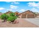 Charming home boasting a two-car garage, desert landscaping, and a welcoming covered entrance at 5433 Escallonia St, Las Vegas, NV 89149