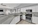 Stylish kitchen boasts stainless steel appliances, stone countertops, white cabinetry, and a breakfast bar at 5433 Escallonia St, Las Vegas, NV 89149