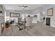 Open-concept living space features wood floors, modern fireplace, dining table, and a view into the kitchen at 5433 Escallonia St, Las Vegas, NV 89149