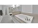 Bright main bathroom with soaking tub, tiled floors, and a separate shower at 5433 Escallonia St, Las Vegas, NV 89149