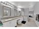 Elegant bathroom featuring dual sinks, white cabinetry, and recessed lighting at 5433 Escallonia St, Las Vegas, NV 89149