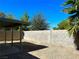 Enclosed backyard with a covered patio and privacy wall, creating a private outdoor space at 5436 Burkshire Dr, Las Vegas, NV 89142