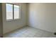 Modest bedroom with tile flooring and a large window at 5436 Burkshire Dr, Las Vegas, NV 89142