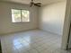 Bright bedroom with clean tile flooring, a ceiling fan and natural light at 5436 Burkshire Dr, Las Vegas, NV 89142