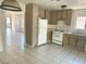 Functional kitchen with white appliances and tile floors, perfect for culinary adventures at 5436 Burkshire Dr, Las Vegas, NV 89142