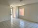 Bright living room with clean tile flooring, neutral walls, and an open layout at 5436 Burkshire Dr, Las Vegas, NV 89142