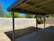 A covered patio sits within a fenced-in yard, offering a shady outdoor retreat for relaxation or entertainment at 5436 Burkshire Dr, Las Vegas, NV 89142