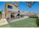 Landscaped backyard with a patio, dining area, and green space, perfect for outdoor living at 5466 Silverheart Ave, Las Vegas, NV 89142