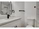 Bathroom featuring a modern vanity, toilet, and a glass-enclosed shower with elegant tile at 5466 Silverheart Ave, Las Vegas, NV 89142