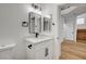 Bathroom with modern vanity, white countertop, black hardware, and two mirrors at 5466 Silverheart Ave, Las Vegas, NV 89142