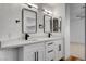 Bathroom with dual sinks, white cabinets, modern black hardware, and clean, updated lighting at 5466 Silverheart Ave, Las Vegas, NV 89142