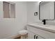 Powder room featuring modern vanity with white countertop and black hardware at 5466 Silverheart Ave, Las Vegas, NV 89142