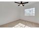 Cozy bedroom with a ceiling fan and a window offering views, carpeted flooring at 5466 Silverheart Ave, Las Vegas, NV 89142