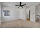 Spacious primary bedroom with neutral carpet and ceiling fan at 5466 Silverheart Ave, Las Vegas, NV 89142
