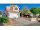 Charming two-story home with a two-car garage, desert landscaping, and a well-maintained front yard at 5466 Silverheart Ave, Las Vegas, NV 89142