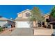 Two-story home featuring a two car garage, mature trees, and well-maintained landscaping at 5466 Silverheart Ave, Las Vegas, NV 89142