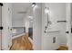 Upstairs hallway featuring updated lighting, wood floors, and a conveniently located half-bath at 5466 Silverheart Ave, Las Vegas, NV 89142